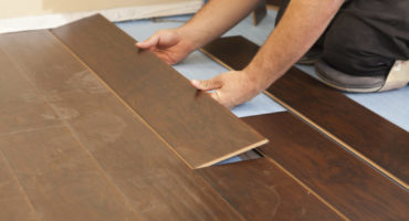 Man Installing New Vinly Plank Flooring